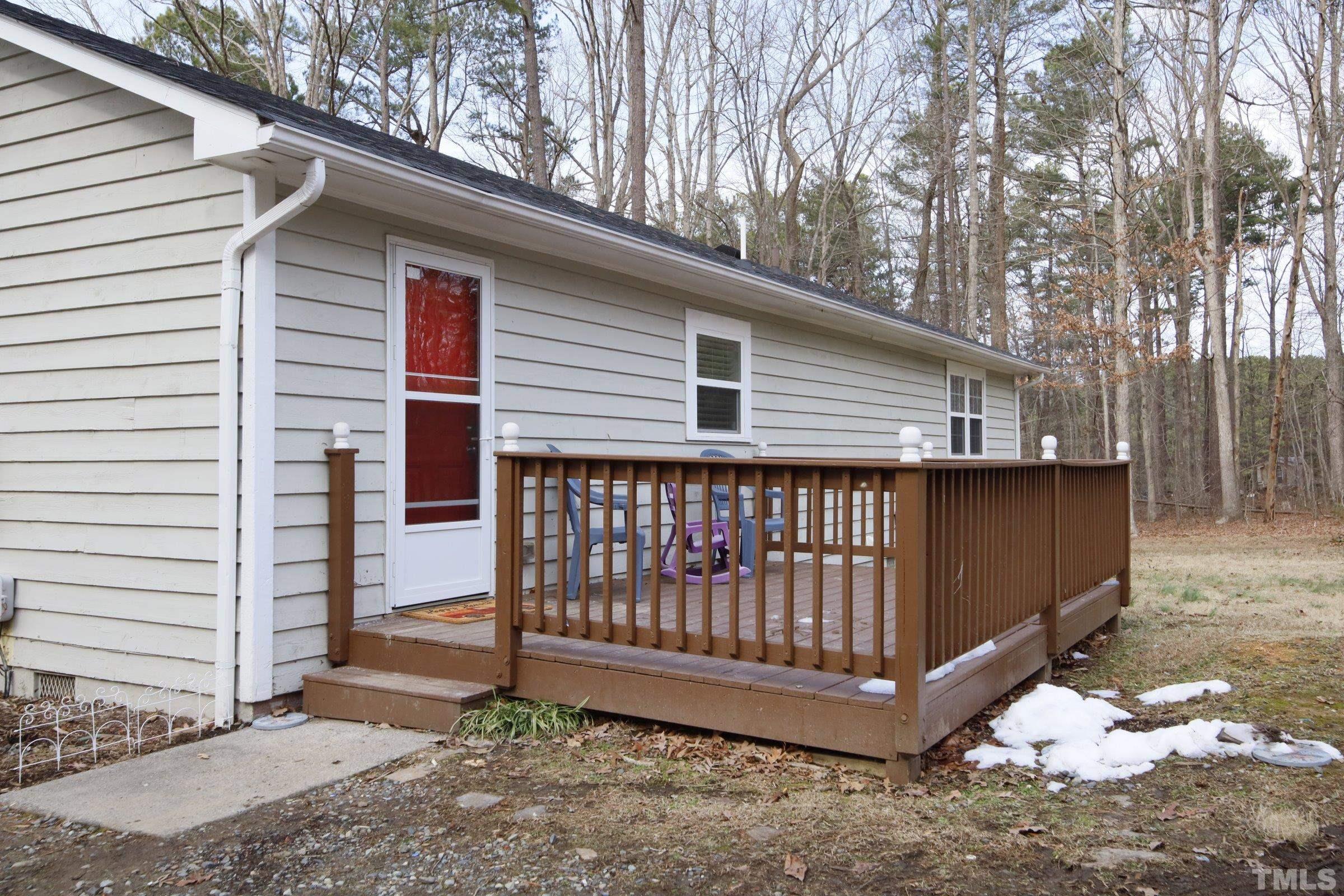 6120 Guess Road Durham, NC 27712 - Photo 18 of 22 a side view of a house with a yard and deck