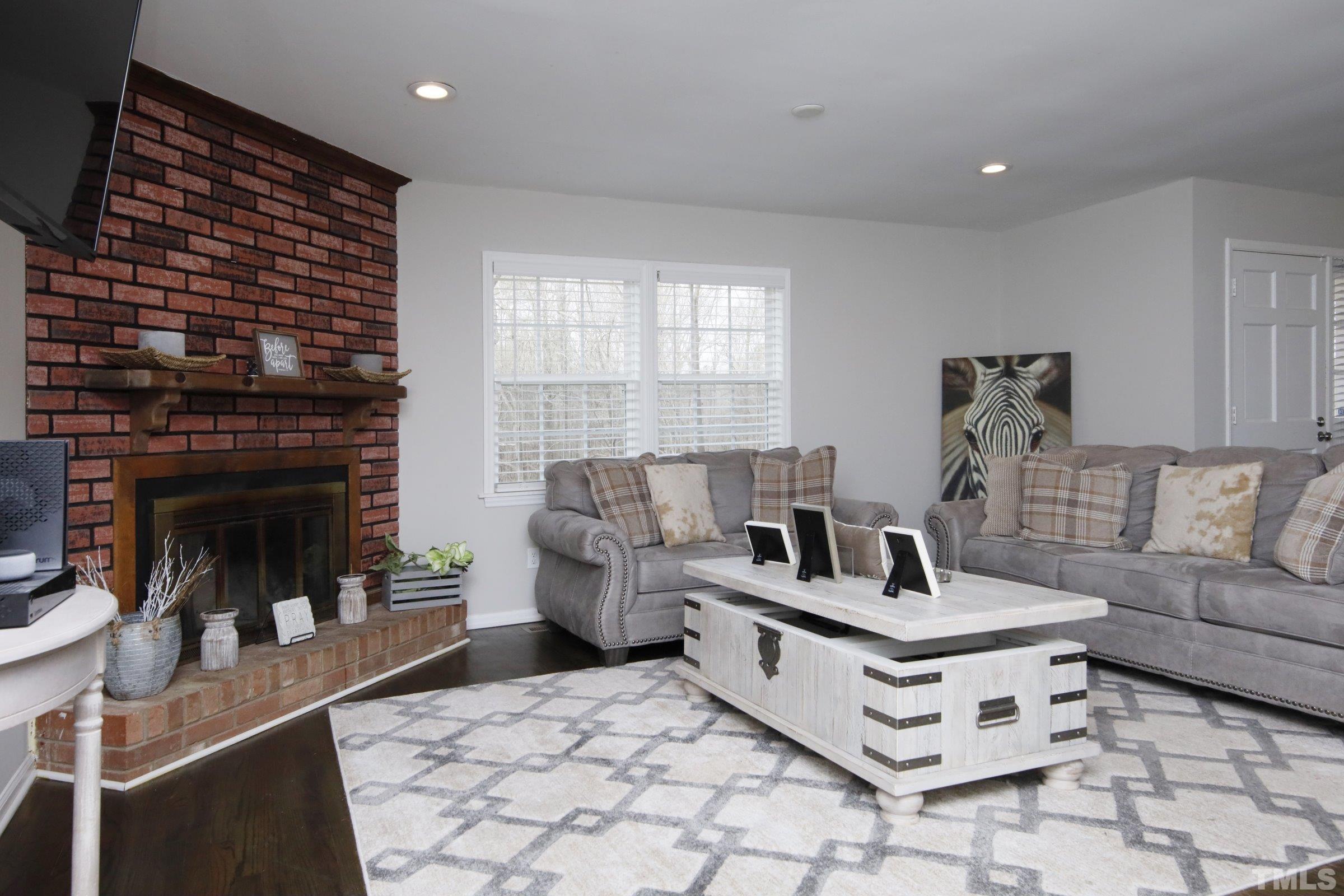 6120 Guess Road Durham, NC 27712 - Photo 3 of 22 a living room with furniture and a fireplace