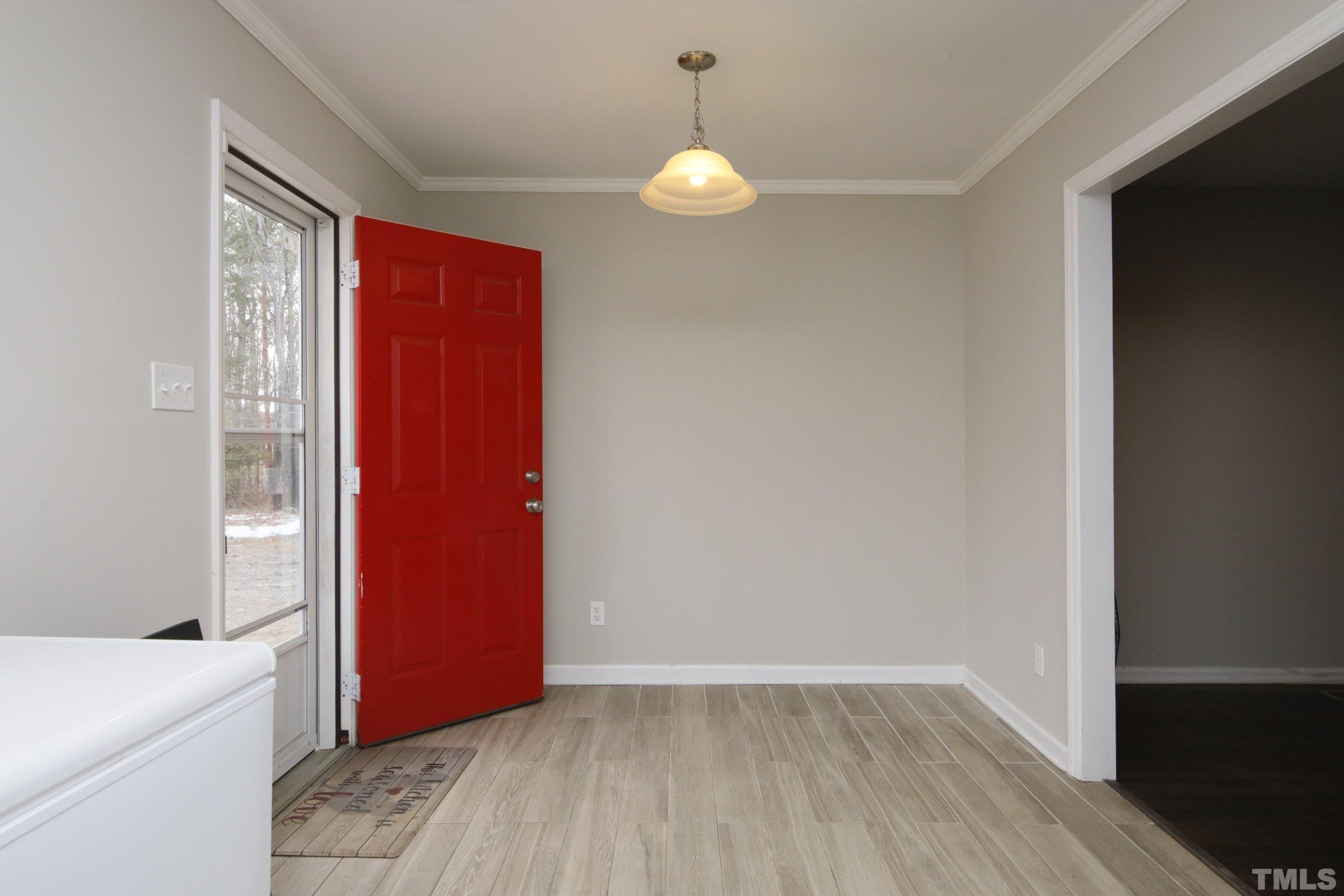 6120 Guess Road Durham, NC 27712 - Photo 9 of 22 a view of a livingroom with wooden floor and cabinet
