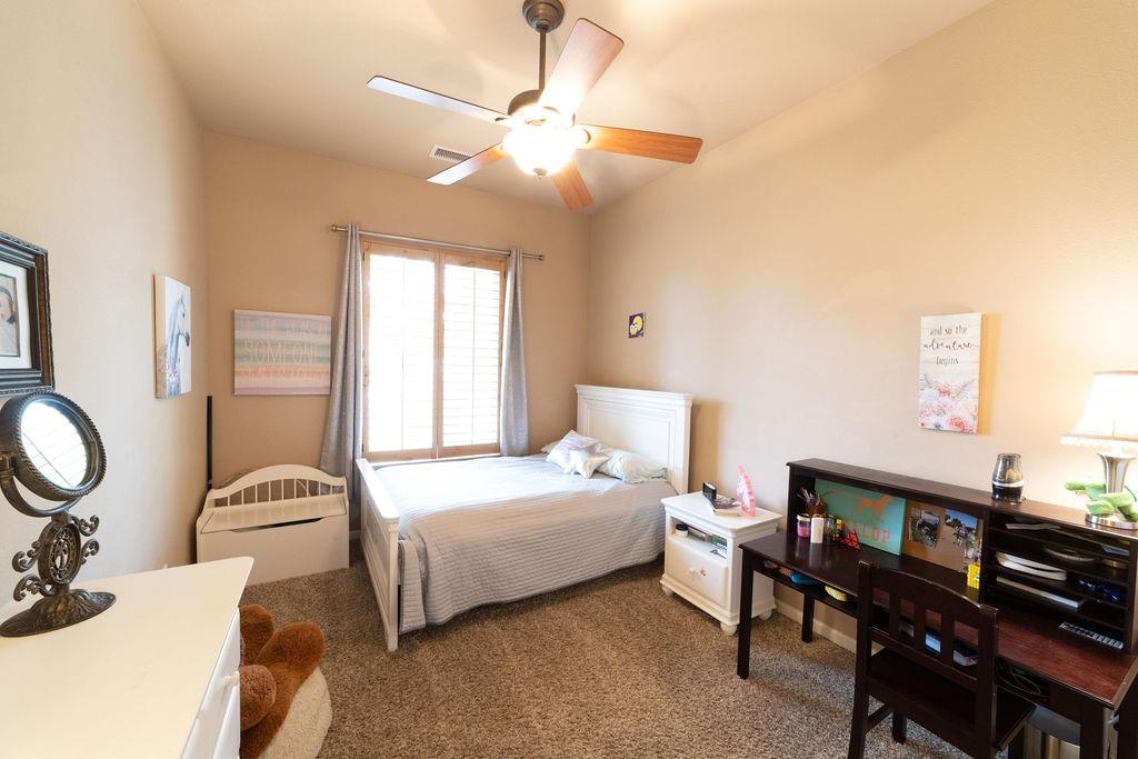 1877 North Coventry Avenue Clovis, CA 93619 - Photo 36 of 61 a bedroom with a bed and a chandelier