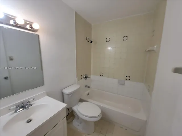 a bathroom with a tub a sink and a shower