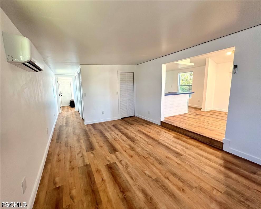 5675 Pine Island Road St. James City, FL 33956 - Photo 4 of 20 a view of a room with wooden floor and a window