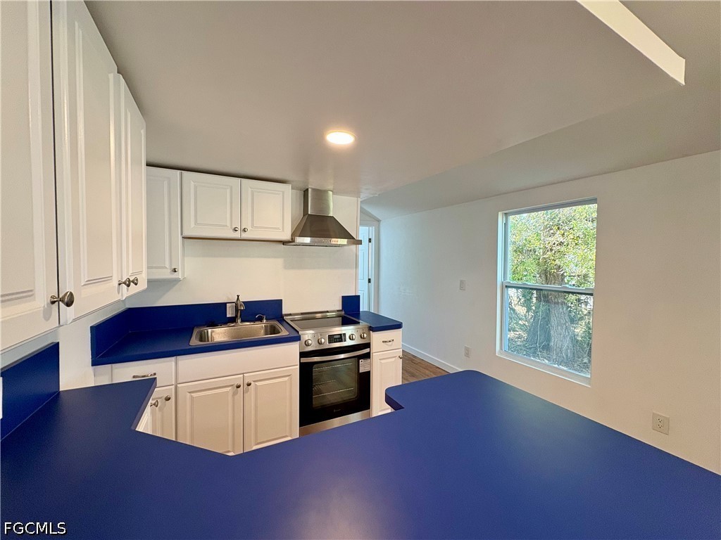 5675 Pine Island Road St. James City, FL 33956 - Photo 9 of 20 a kitchen with stainless steel appliances granite countertop a stove a sink and a microwave