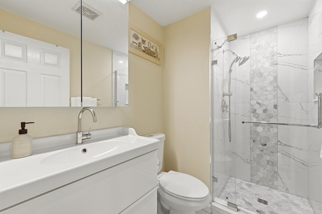 149 Bolivar Street, Unit B2 Canton, MA 02021 - Photo 14 of 34 a bathroom with a sink a toilet and shower