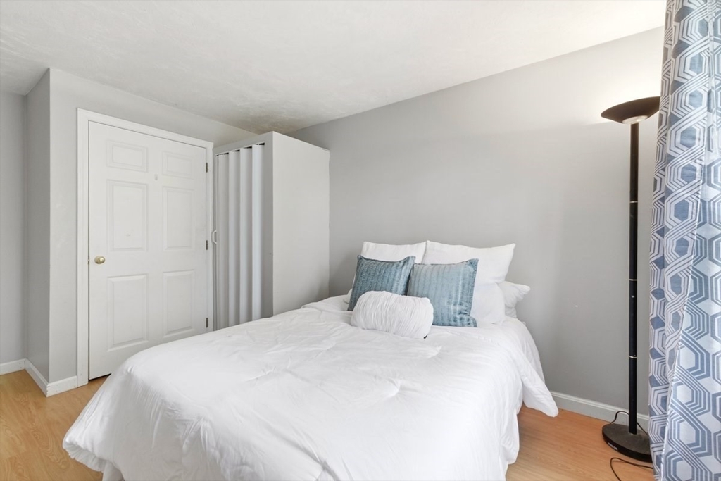 149 Bolivar Street, Unit B2 Canton, MA 02021 - Photo 19 of 34 a large bed in a bedroom next to a bathroom