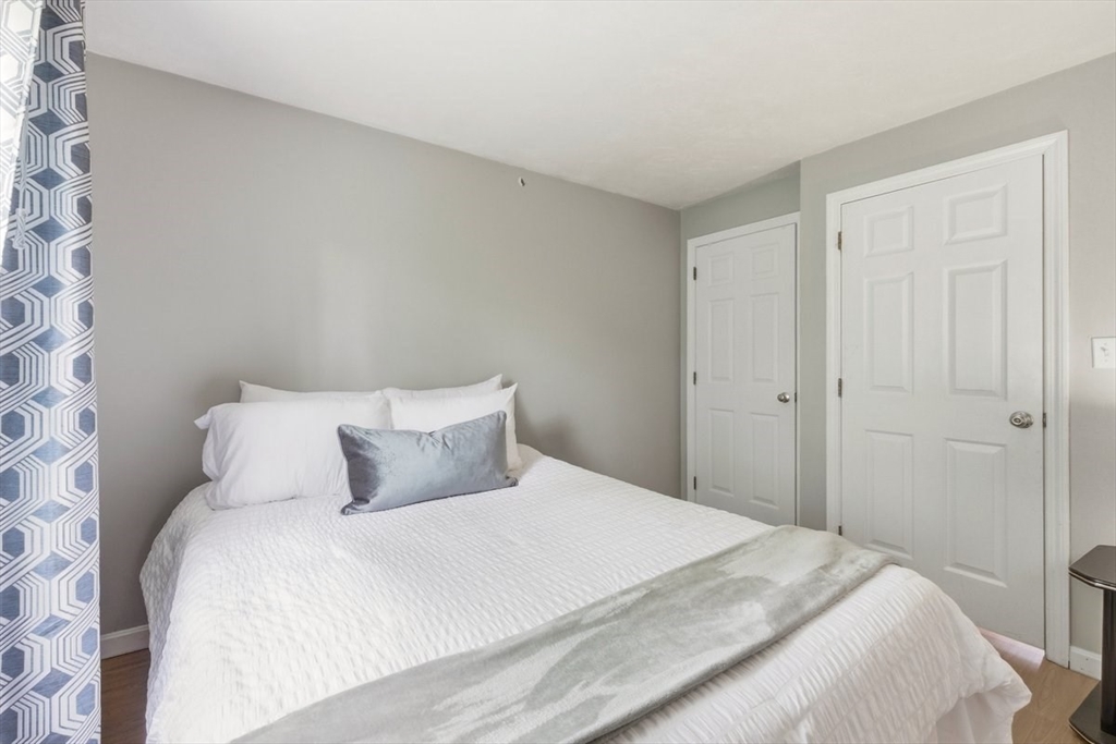 149 Bolivar Street, Unit B2 Canton, MA 02021 - Photo 20 of 34 a bedroom with a bed and a mirror