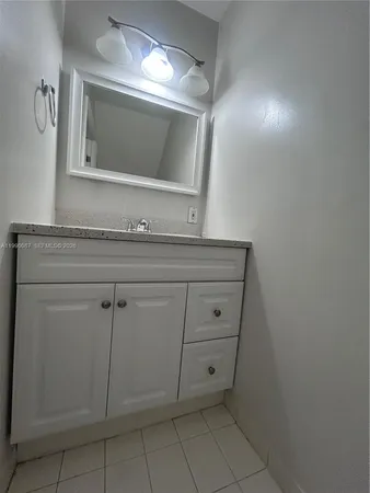 a bathroom with a sink a vanity and mirror