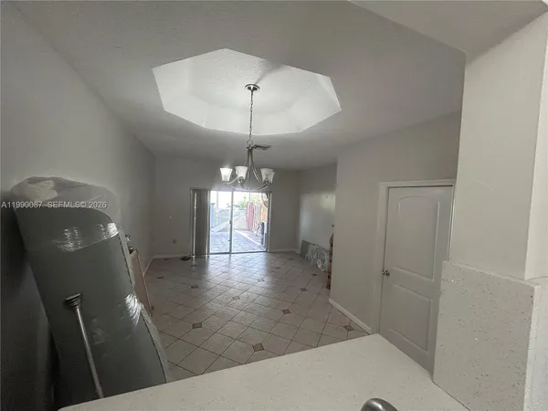 wooden floor in an empty room with a bathroom