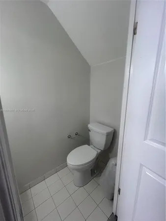 a toilet sitting in a bathroom next to a sink