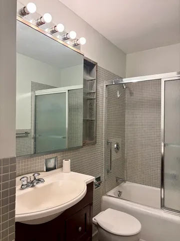 a bathroom with a sink toilet and shower