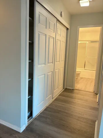 an empty room with wooden floor and a window