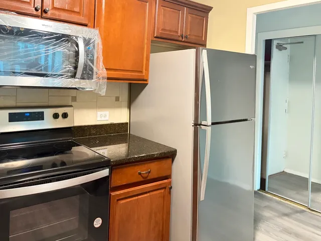 a kitchen with a refrigerator and cabinets