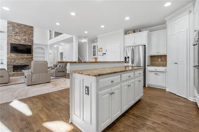 a kitchen with white cabinets and stainless steel appliances
