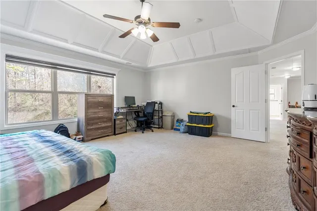 a spacious bedroom with a bed and a large window