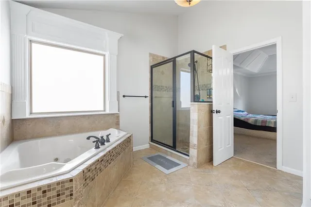 a bathroom with a tub and a shower