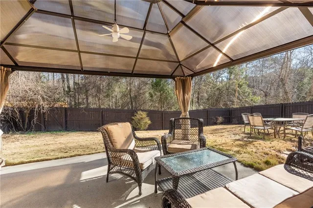 a backyard of a house with table and chairs
