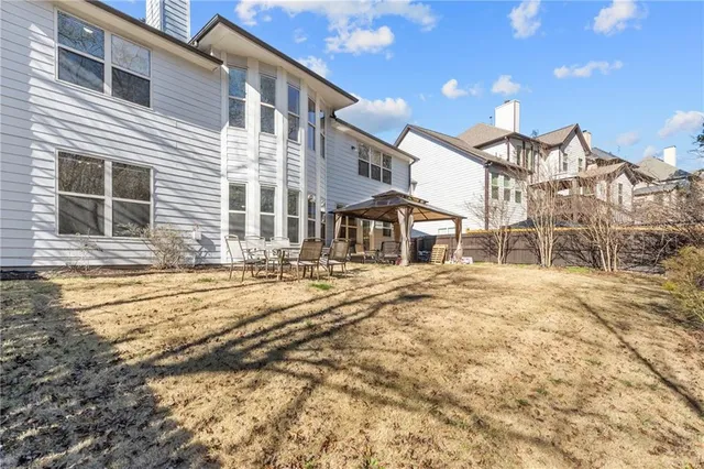 a backyard of a house with large trees