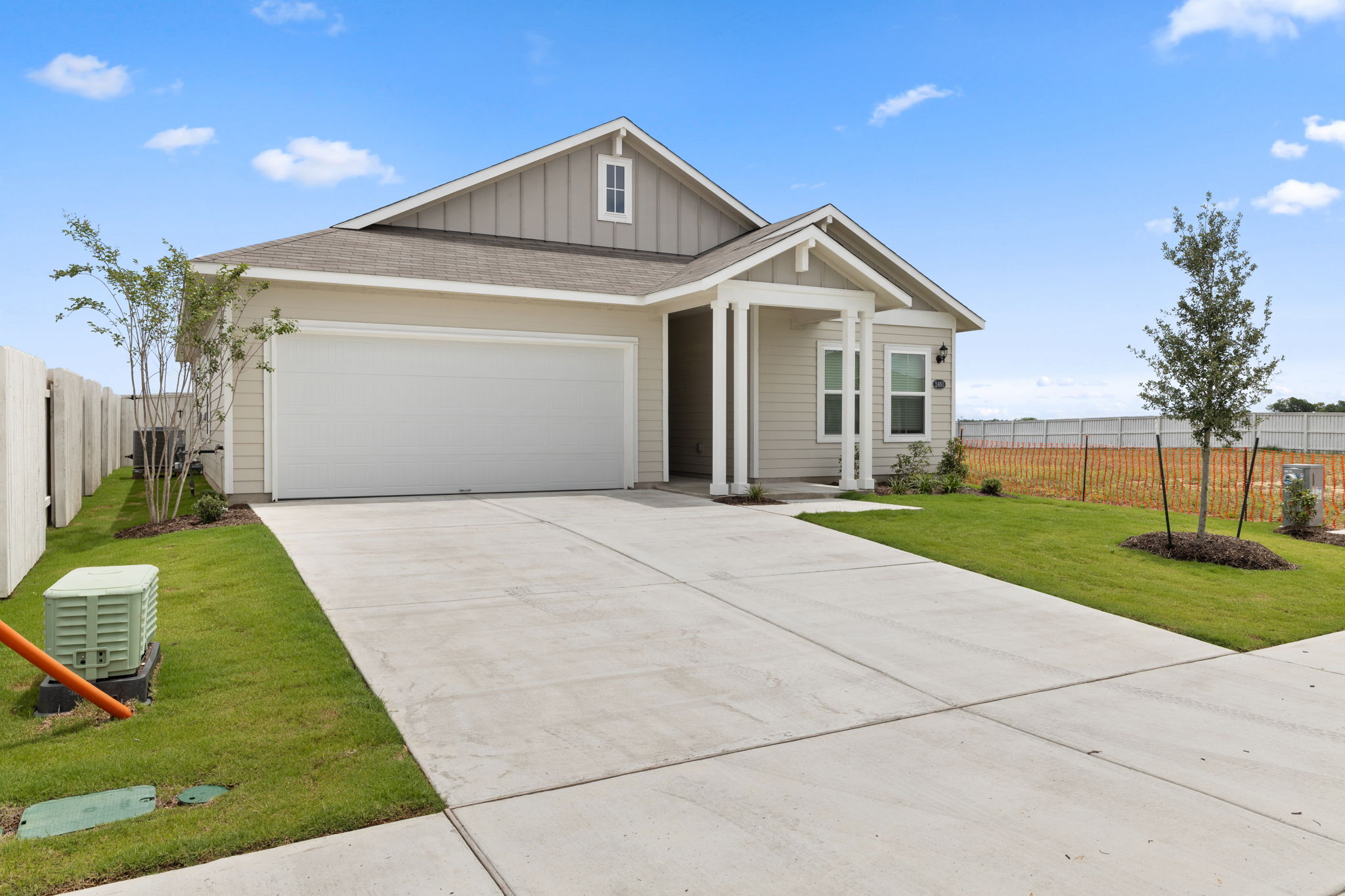 2460 Winding Creek Road Kyle, TX 78640 - Photo 3 of 20 A welcoming facade presents a single-story residence with a prominent garage and a neatly landscaped front yard.