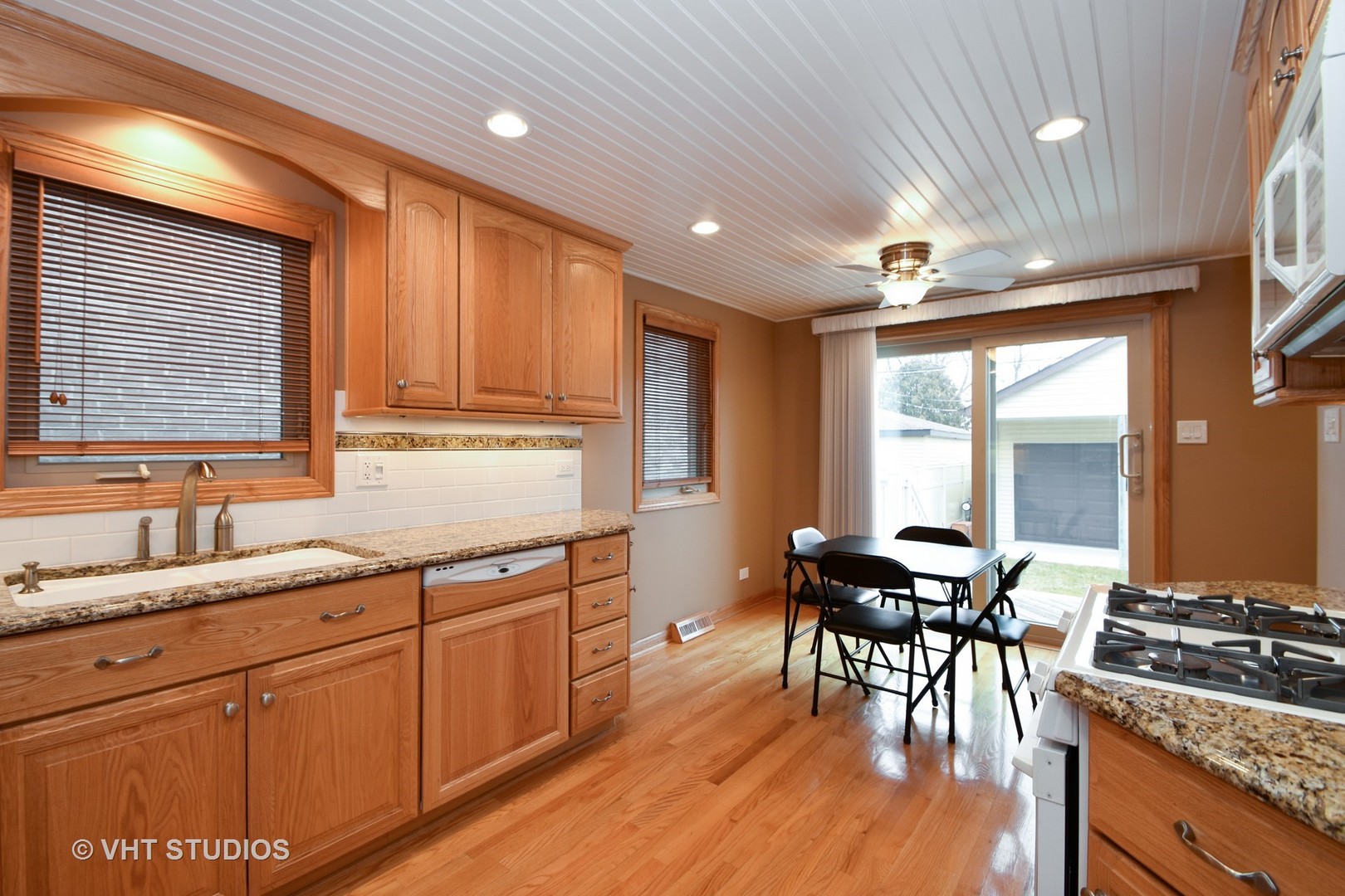 5155 South Mobile Avenue Chicago, IL 60638 - Photo 4 of 10 a kitchen with stainless steel appliances granite countertop sink stove and wooden cabinets
