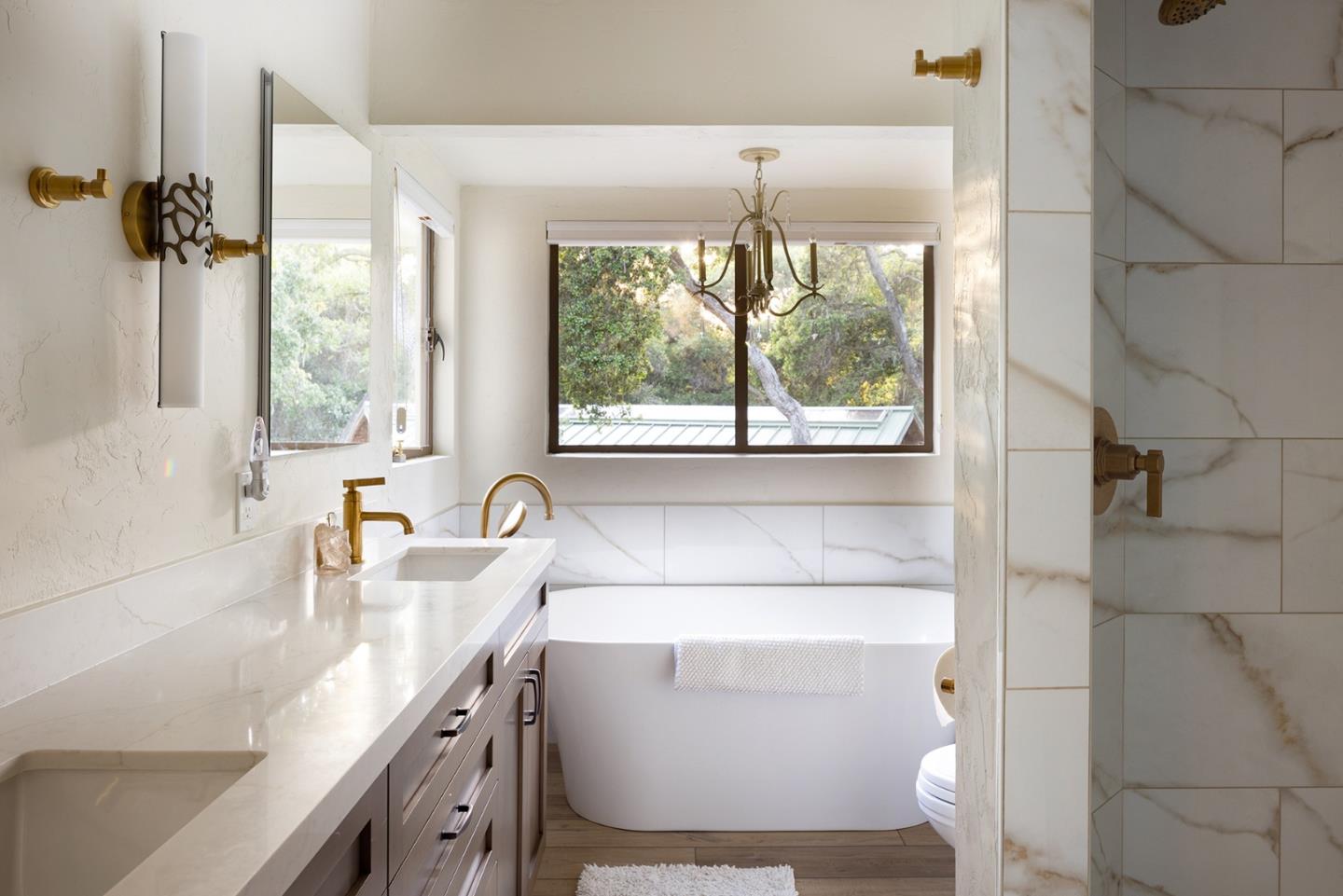 2 A La Rancheria Carmel Valley, CA 93924 - Photo 23 of 46 a bathroom with a granite countertop sink a large mirror and a shower
