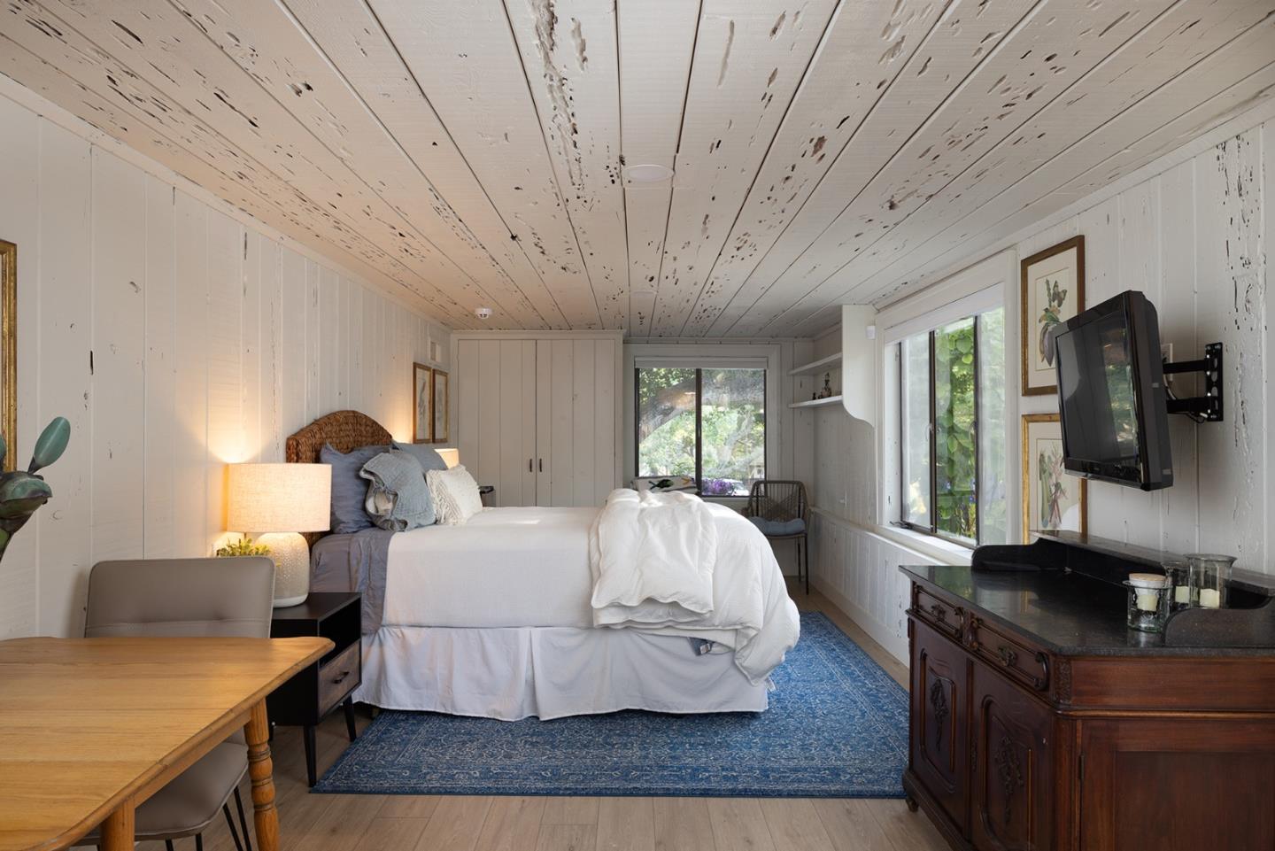 2 A La Rancheria Carmel Valley, CA 93924 - Photo 25 of 46 a spacious bedroom with a bed and wooden floor