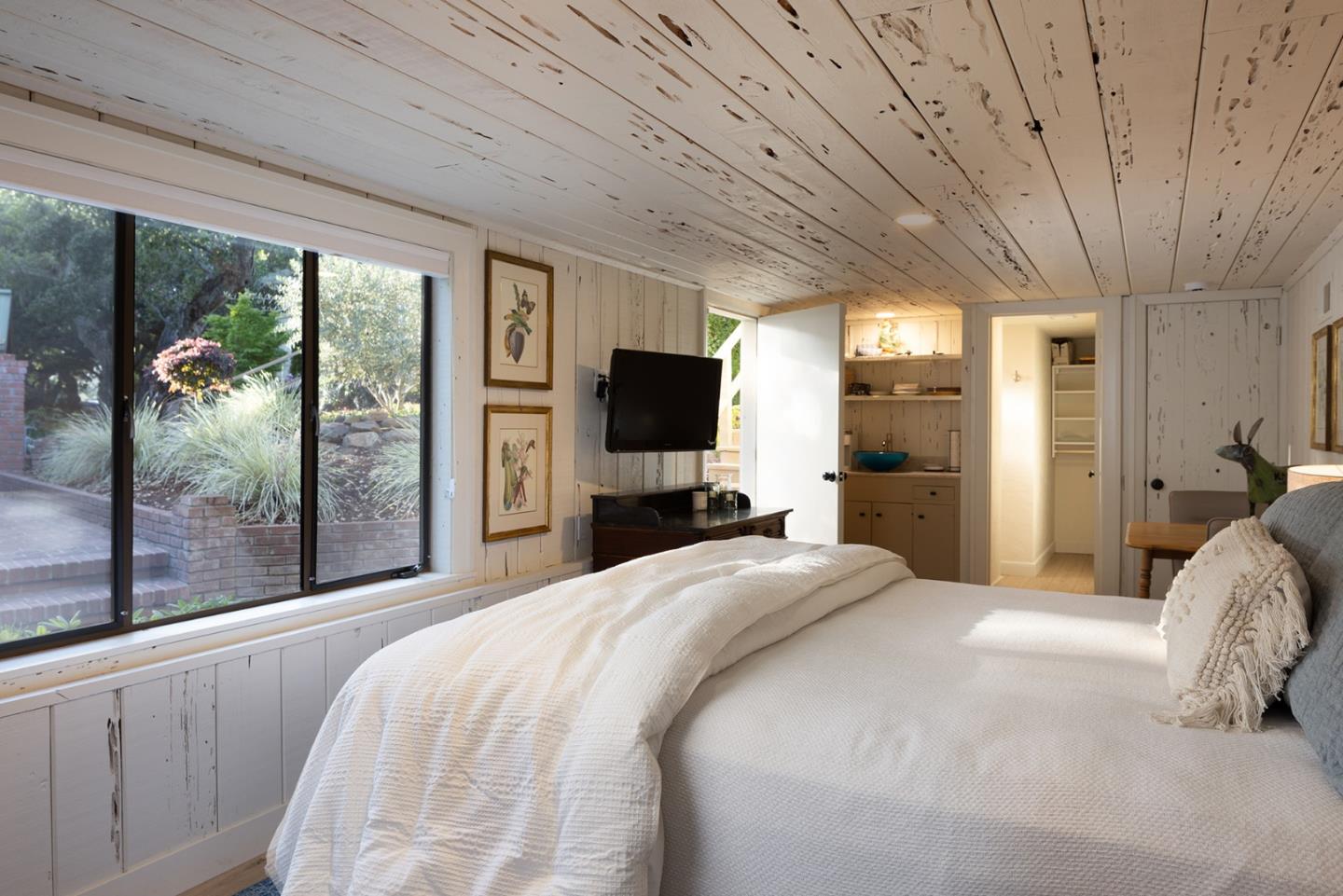 2 A La Rancheria Carmel Valley, CA 93924 - Photo 26 of 46 a bedroom with a large bed and a flat tv screen