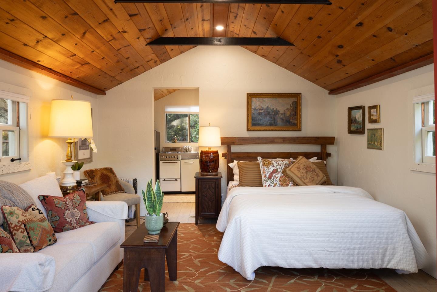 2 A La Rancheria Carmel Valley, CA 93924 - Photo 32 of 46 a spacious bedroom with a bed a couch and paintings on the wall