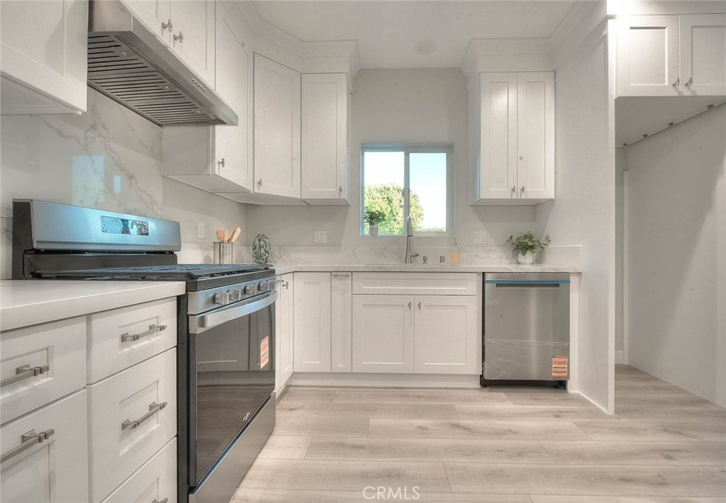 752 Rio Del Sol Avenue Montebello, CA 90640 - Photo 30 of 62 a kitchen with granite countertop white cabinets and white appliances