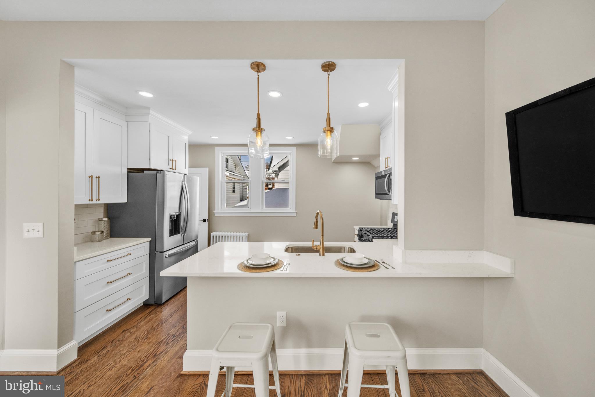 6018 2nd Street Northwest Washington, DC 20011 - Photo 5 of 18 a kitchen with stainless steel appliances kitchen island granite countertop a sink cabinets and wooden floor