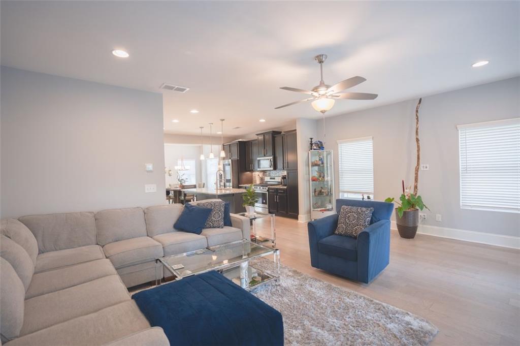 Undisclosed Address Atlanta, GA 30318 - Photo 14 of 19 a living room with furniture ceiling fan and a rug