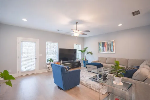 a kitchen with kitchen island granite countertop wooden cabinets a refrigerator and a sink