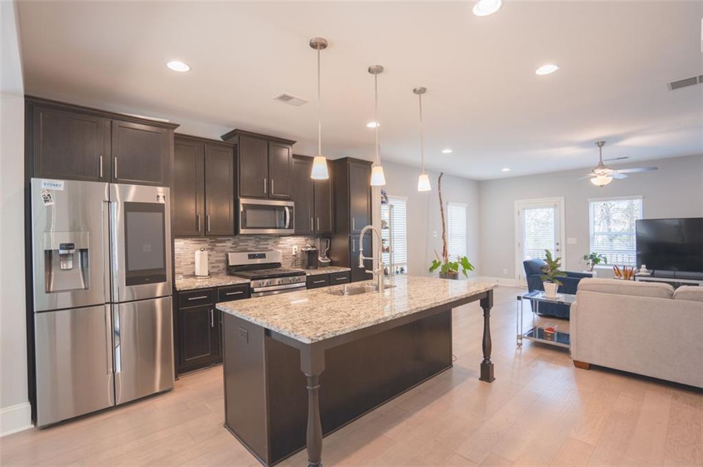 Undisclosed Address Atlanta, GA 30318 - Photo 18 of 19 a kitchen with stainless steel appliances granite countertop a refrigerator a stove a sink a oven and a refrigerator