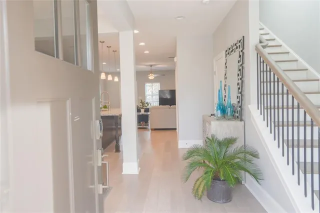 a view of a hallway view with wooden floor and a potted plant