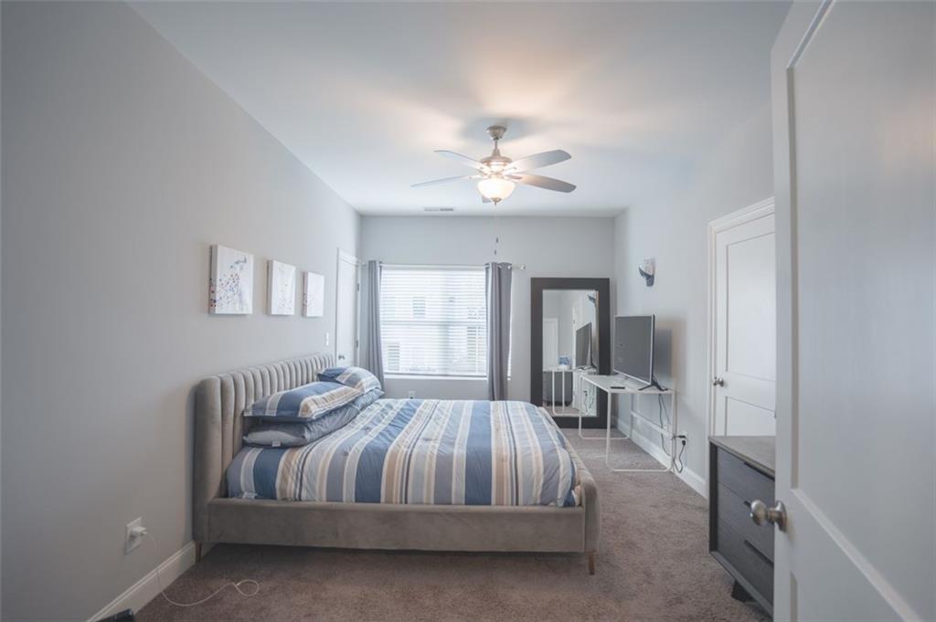 Undisclosed Address Atlanta, GA 30318 - Photo 8 of 19 a bedroom with a bed and a chandelier