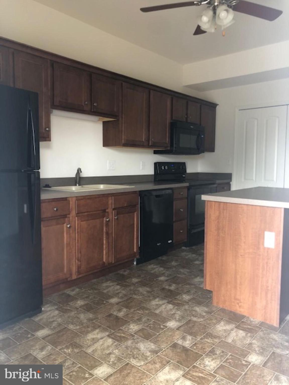 525 Hometowne Terrace Lititz, PA 17543 - Photo 2 of 11 a kitchen with stainless steel appliances granite countertop a stove a sink and a refrigerator