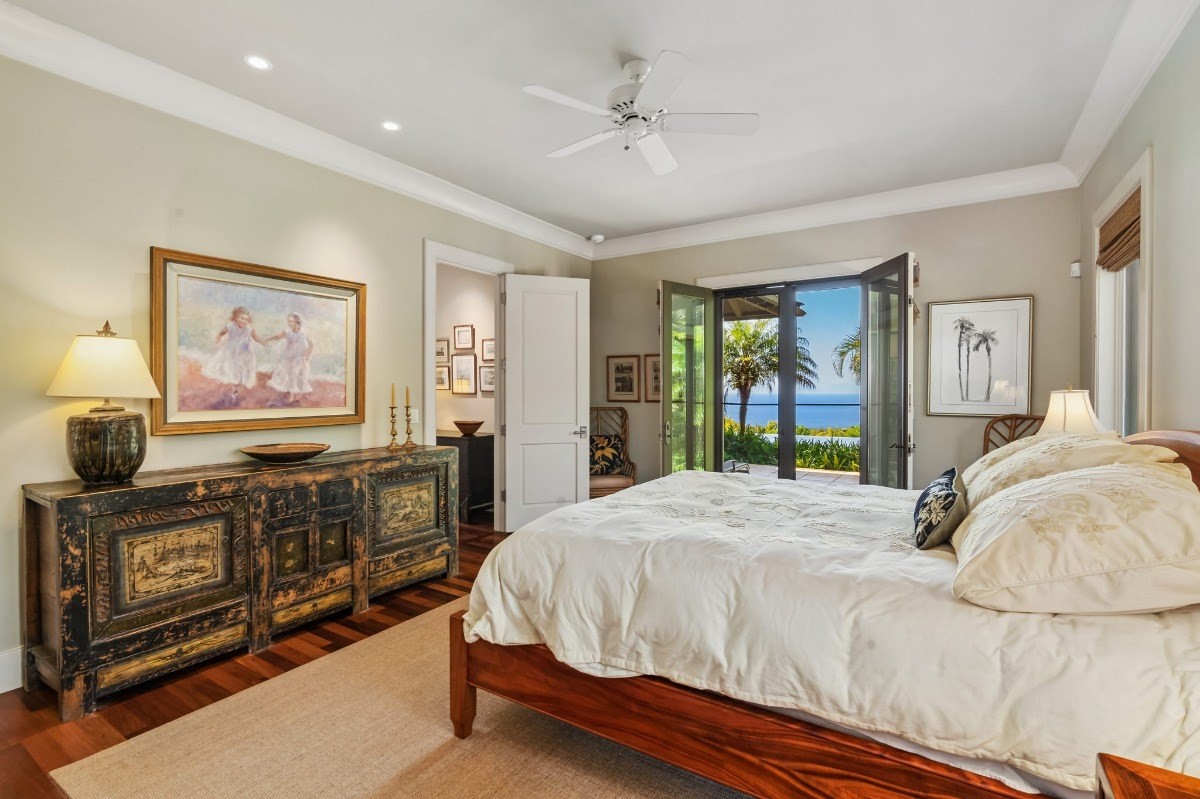 1050 F Puu Road, Unit 1 Kalaheo, HI 96741 - Photo 12 of 25 a bedroom with a bed dresser and a flat tv screen