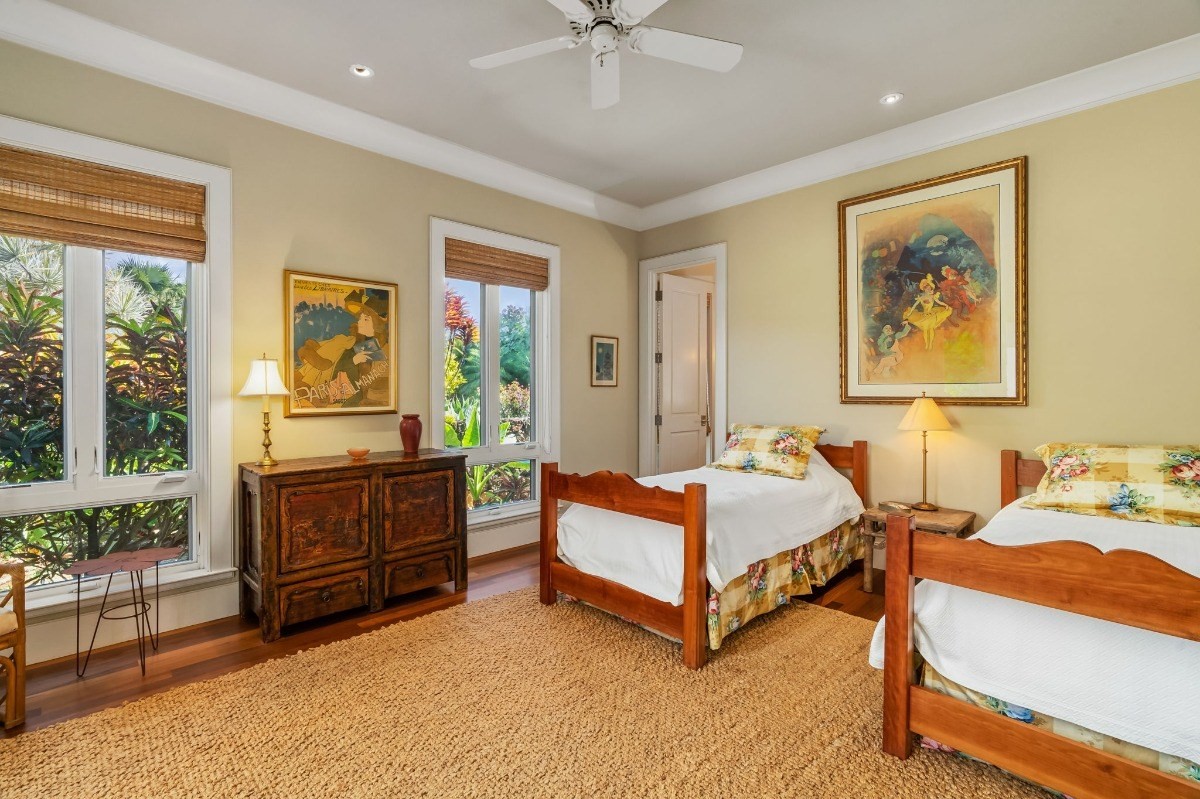 1050 F Puu Road, Unit 1 Kalaheo, HI 96741 - Photo 18 of 25 a spacious bedroom with a bed and a chandelier