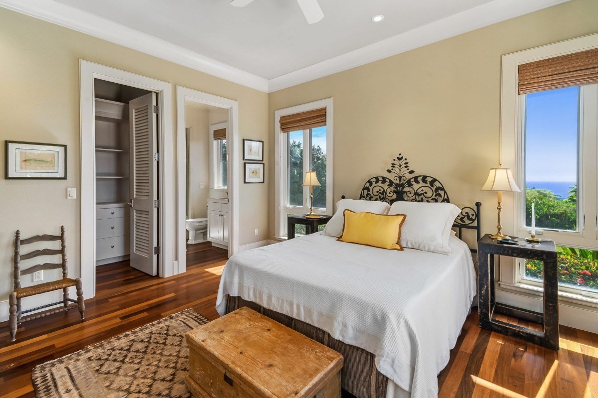 1050 F Puu Road, Unit 1 Kalaheo, HI 96741 - Photo 20 of 25 a bedroom with a bed and wooden floor