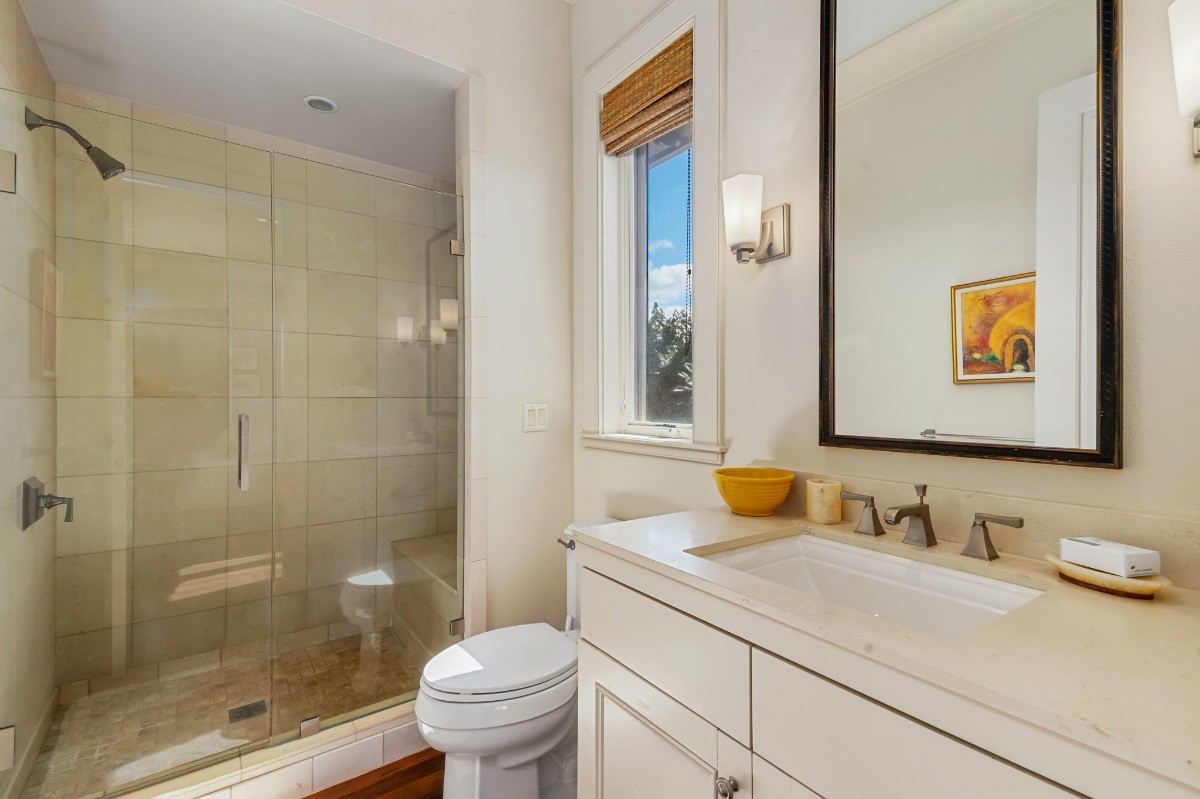1050 F Puu Road, Unit 1 Kalaheo, HI 96741 - Photo 22 of 25 a bathroom with a granite countertop sink and a mirror