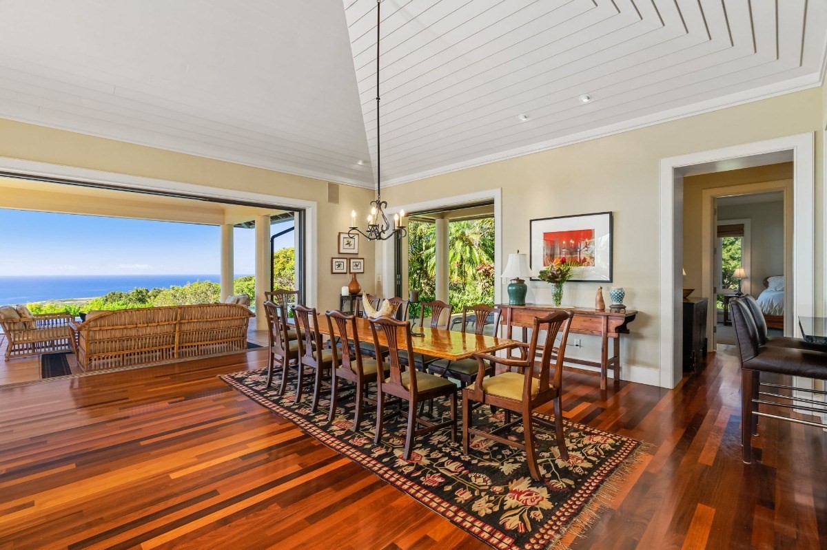 1050 F Puu Road, Unit 1 Kalaheo, HI 96741 - Photo 8 of 25 a view of a dining room with furniture window and wooden floor