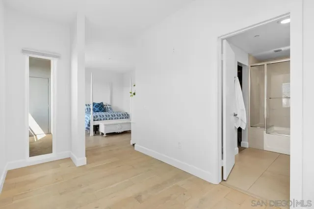 a bathroom with a double vanity sink a mirror and a bathtub