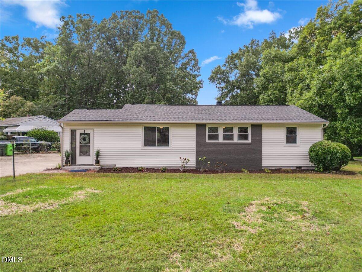 3437 Apache Drive Raleigh, NC 27609 - Photo 2 of 40 Exterior with a dark accent wall, shingle roof, and established landscaping