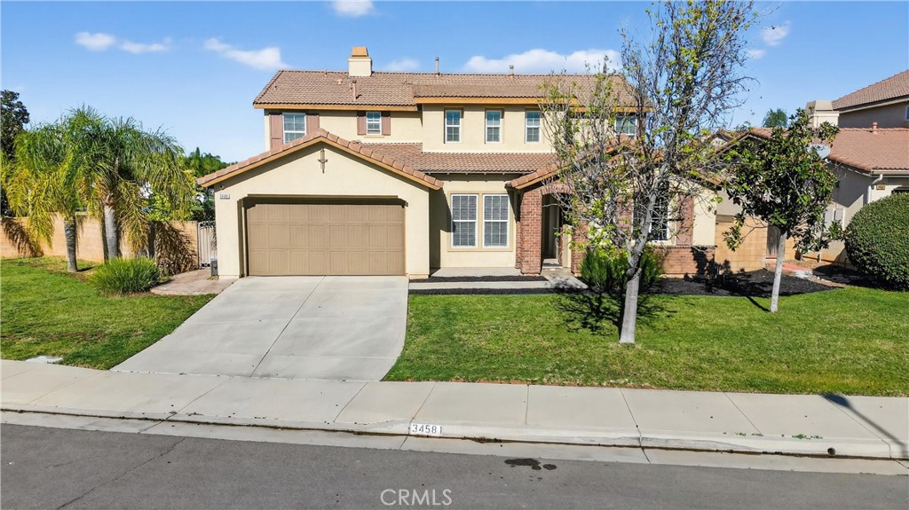 34581 Spindle Tree Street Winchester, CA 92596 - Photo 1 of 50 a front view of a house with a yard and potted plants