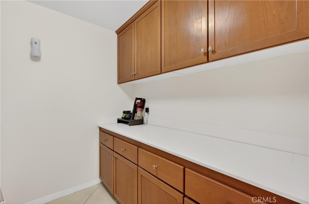 34581 Spindle Tree Street Winchester, CA 92596 - Photo 14 of 50 a kitchen with cabinets and white stainless steel appliances