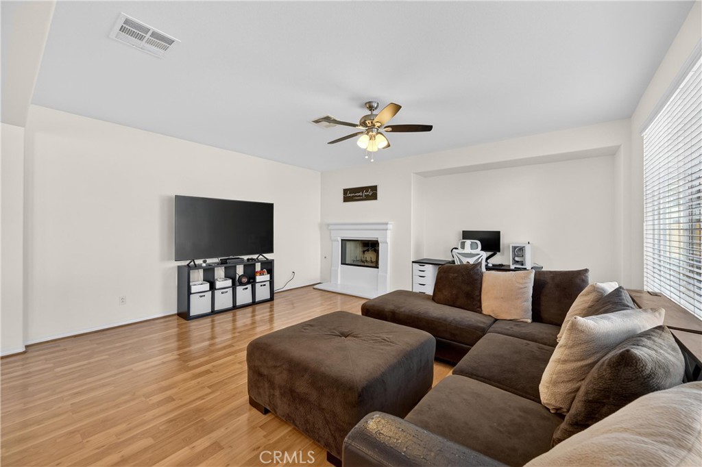 34581 Spindle Tree Street Winchester, CA 92596 - Photo 17 of 50 a living room with furniture a flat screen tv and a window