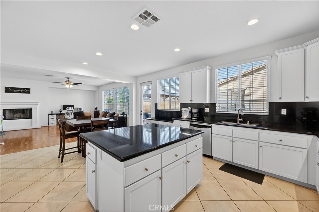 34581 Spindle Tree Street Winchester, CA 92596 - Photo 27 of 50 a kitchen with granite countertop a sink counter top space appliances and cabinets