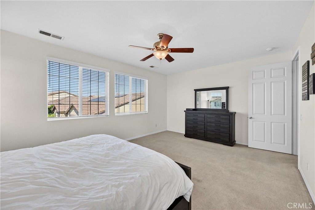 34581 Spindle Tree Street Winchester, CA 92596 - Photo 40 of 50 a spacious bedroom with a large bed and a window