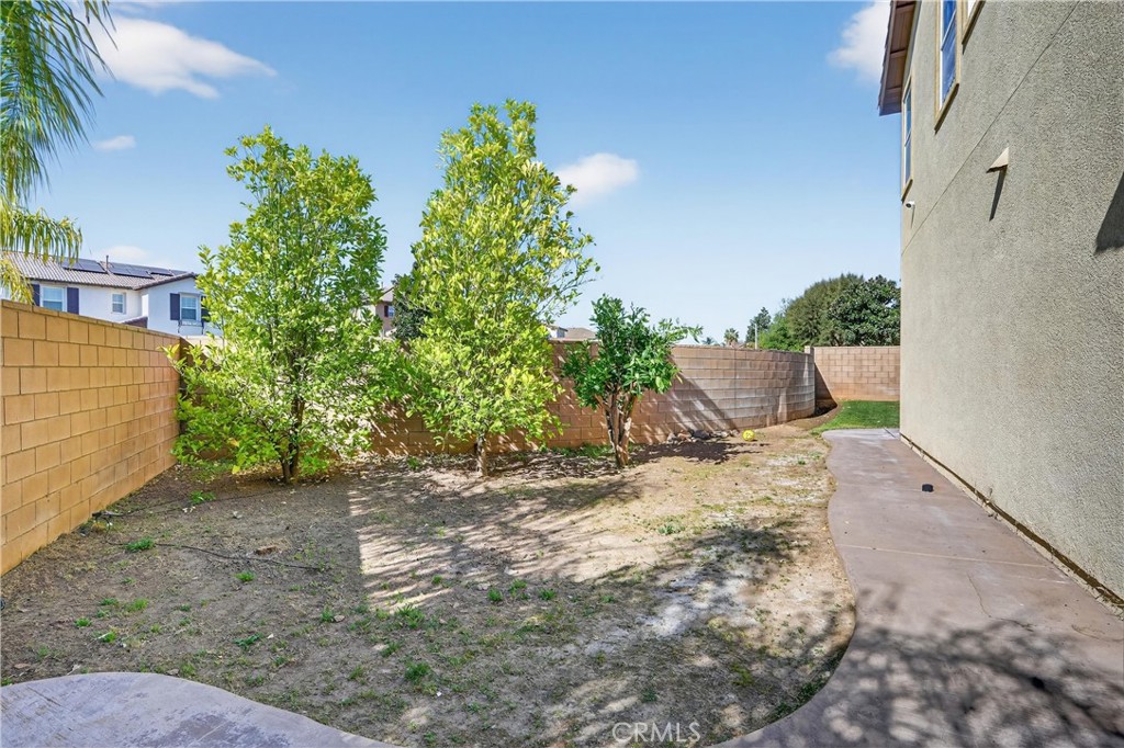 34581 Spindle Tree Street Winchester, CA 92596 - Photo 43 of 50 a view of a yard with plants and wooden fence