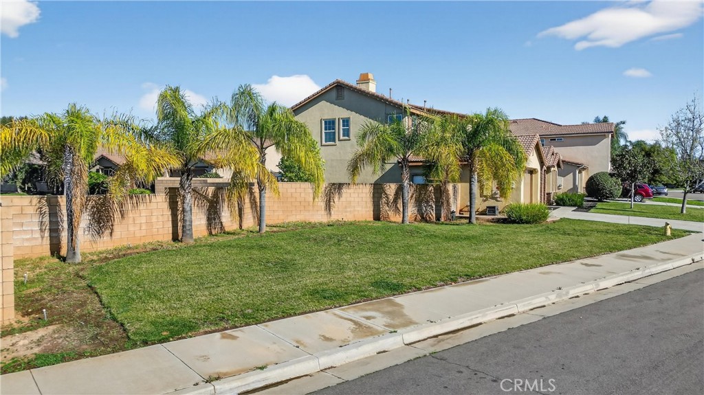 34581 Spindle Tree Street Winchester, CA 92596 - Photo 5 of 50 a front view of a house with a yard and potted plants