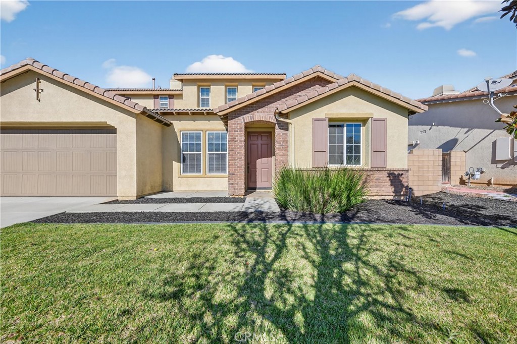 34581 Spindle Tree Street Winchester, CA 92596 - Photo 7 of 50 a front view of a house with a yard